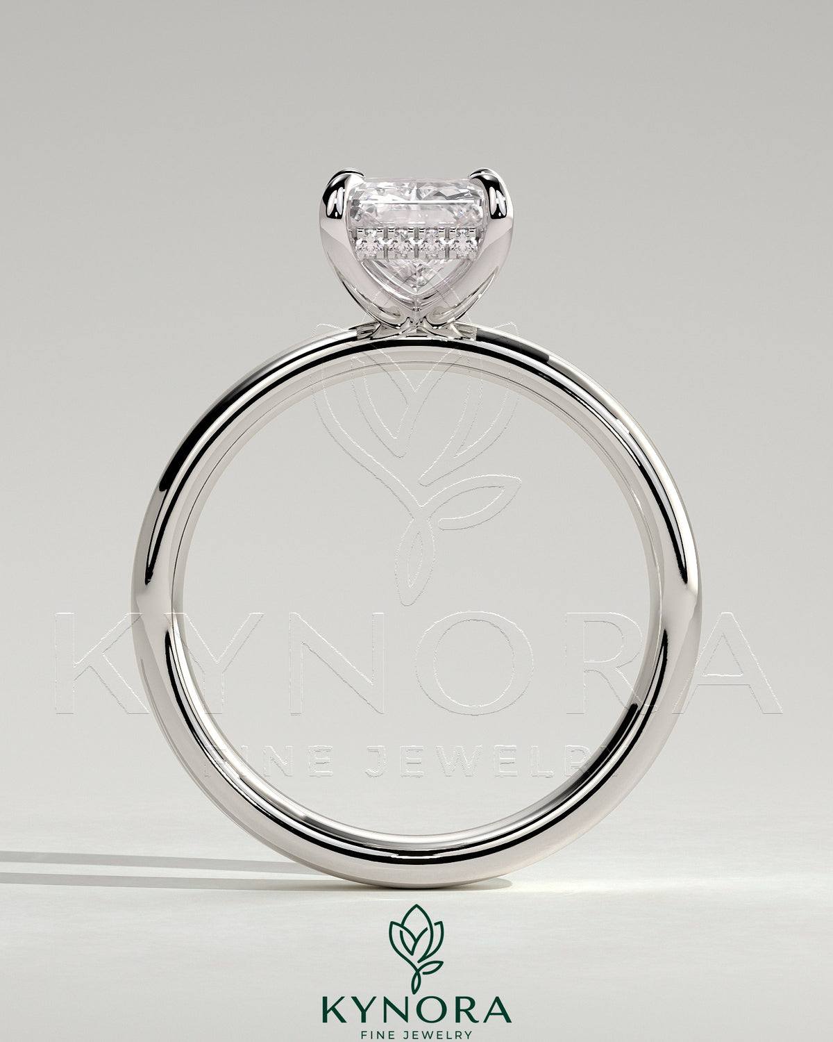 Kynora CJ 2ct radiant cut diamond claw solitaire engagement ring with cigar band and hidden halo, crafted in elegant jewelry style.
