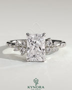 Kynora CJ 2ct radiant claw solitaire engagement ring with clustered round shoulder stones, elegant solitaire ring design.
