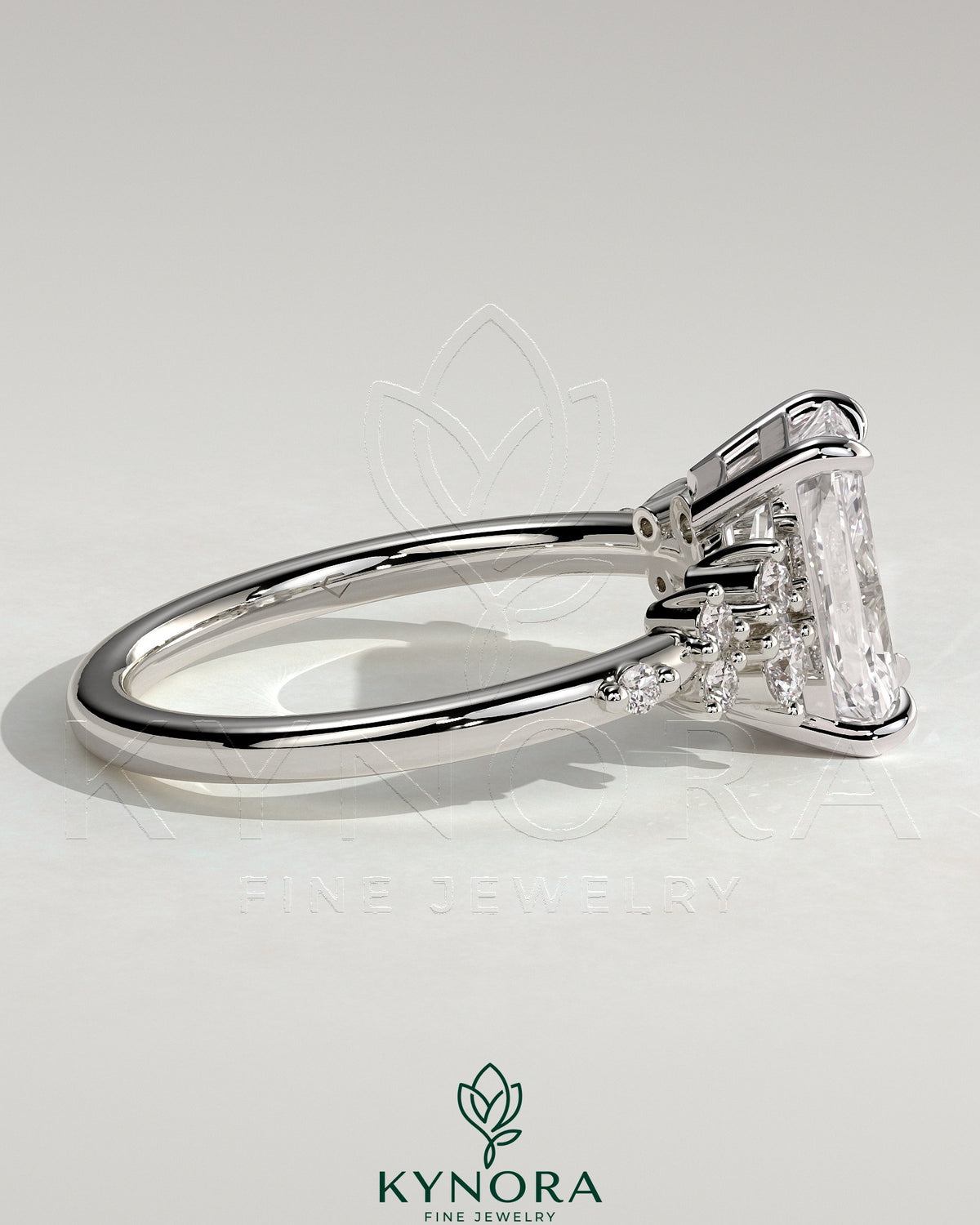 Kynora CJ 2ct radiant claw solitaire engagement ring with clustered round shoulder stones, featuring a polished gold band.