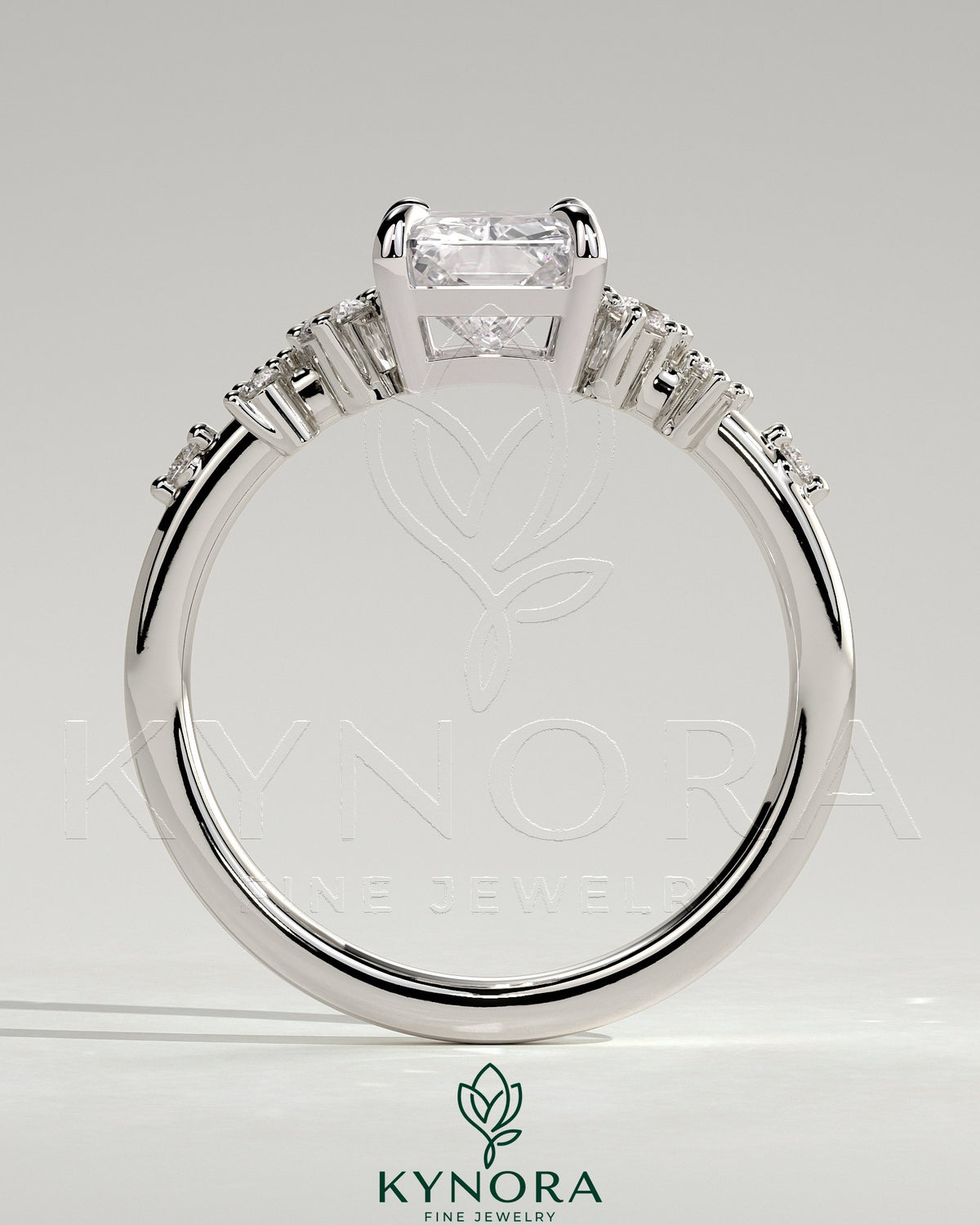 Kynora CJ 2ct radiant claw solitaire engagement ring with clustered round shoulder stones, showcasing elegant jewelry design.