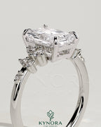 Kynora CJ 2ct radiant claw solitaire engagement ring with clustered round shoulder stones, showcasing elegant diamond craftsmanship.