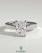 Kynora CJ 2ct radiant cut claw solitaire engagement ring with flat cigar band and hidden halo design.