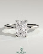 Kynora CJ 2ct radiant claw solitaire engagement ring with hidden halo and floating cathedral low setting, showcasing sparkling diamond.