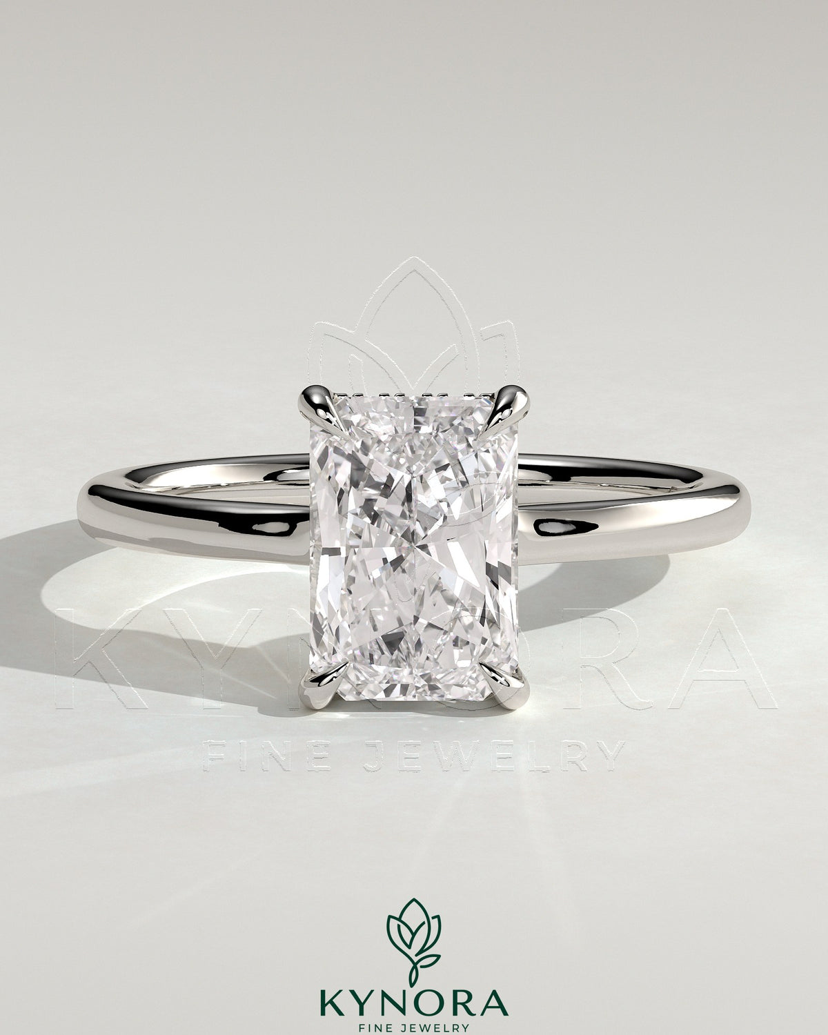Kynora CJ 2ct radiant claw solitaire engagement ring with hidden halo and floating cathedral low setting, showcasing sparkling diamond.