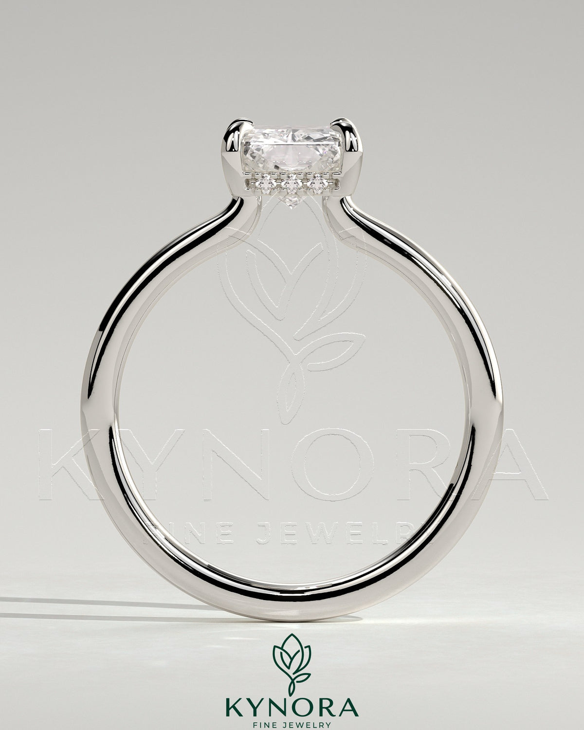 Kynora CJ 2ct radiant claw solitaire engagement ring with hidden halo and floating cathedral low setting, showcasing sparkling diamond.