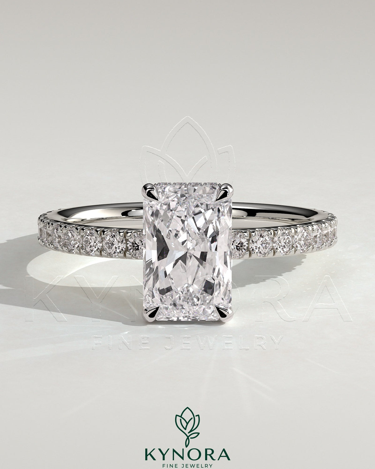Kynora CJ 2ct radiant claw solitaire engagement ring with hidden halo and pave band, featuring a sparkling central diamond. Main image