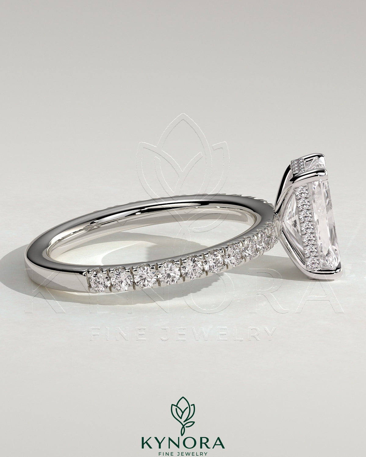 Kynora CJ 2ct radiant diamond claw solitaire engagement ring with hidden halo and pave band, elegant and sparkling jewelry piece.