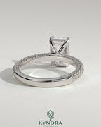 Kynora CJ 2ct radiant claw solitaire engagement ring with hidden halo and triple pave band, showcasing sparkling diamond design.