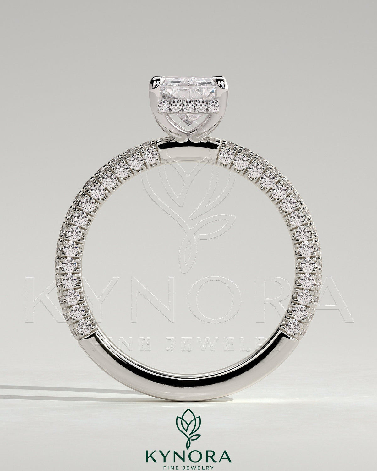 Kynora CJ 2ct radiant cut solitaire engagement ring with hidden halo and triple pave band, showcasing intricate diamond setting.
