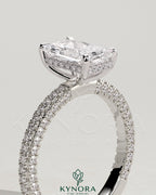 Kynora CJ 2ct radiant diamond solitaire engagement ring with hidden halo and triple pave band, featuring intricate metalwork.