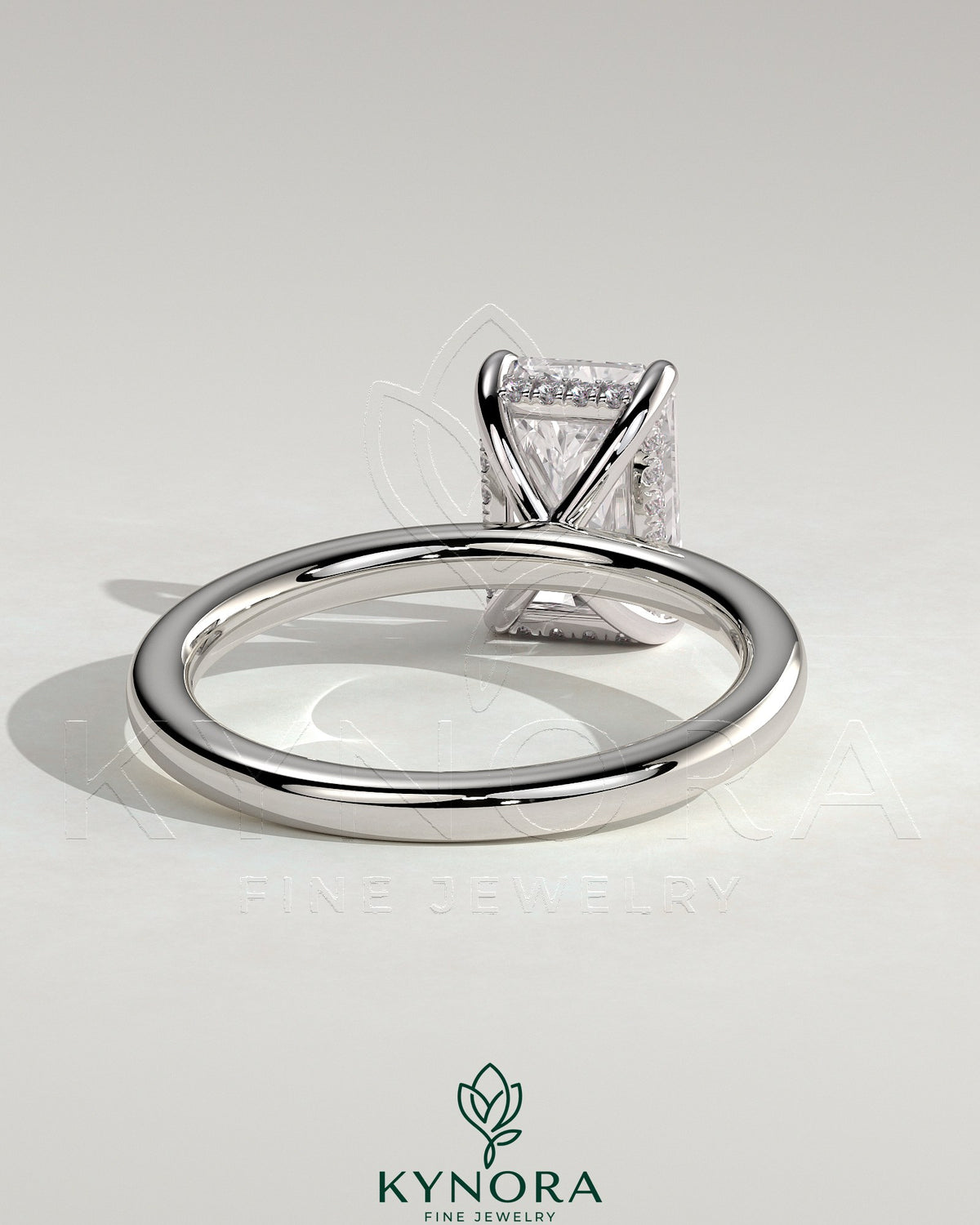 Kynora CJ 2ct radiant cut solitaire engagement ring with hidden halo design, featuring a sparkling diamond setting and elegant band.