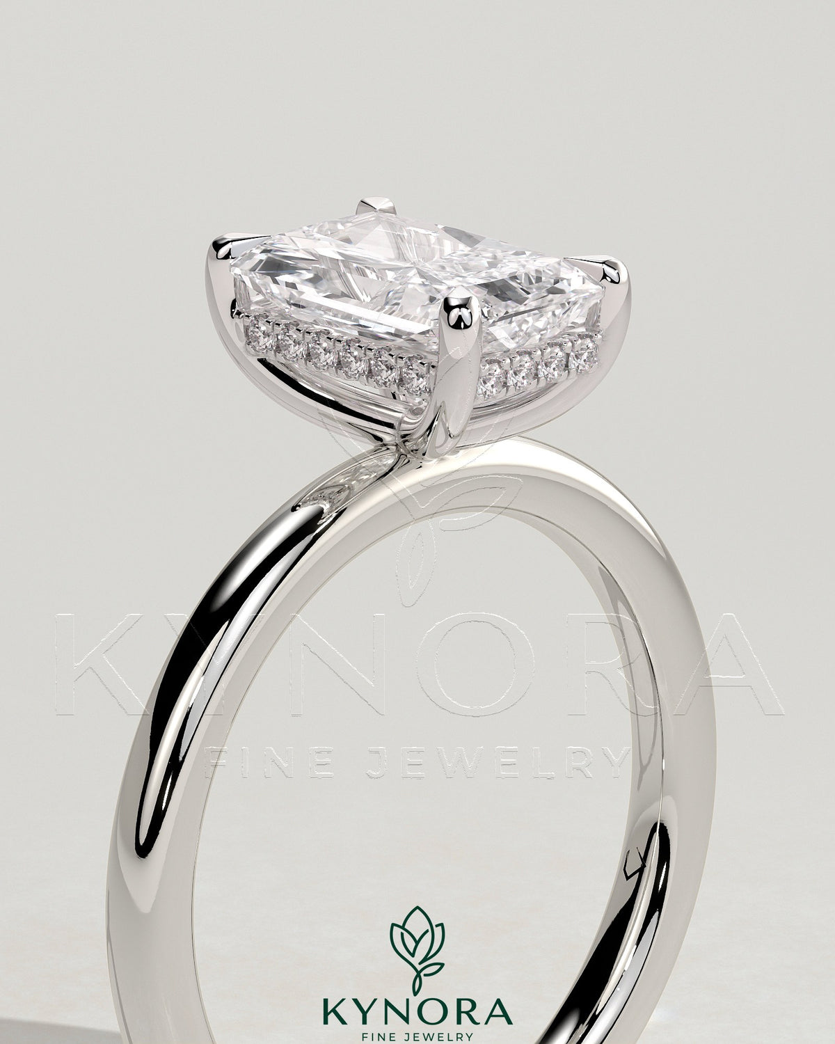 Kynora CJ 2ct Radiant Claw Solitaire Engagement Ring with Hidden Halo, featuring a sparkling central gemstone and elegant band.