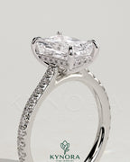 Kynora CJ 2ct radiant diamond claw solitaire engagement ring with hidden halo, pave band, and cathedral high setting.