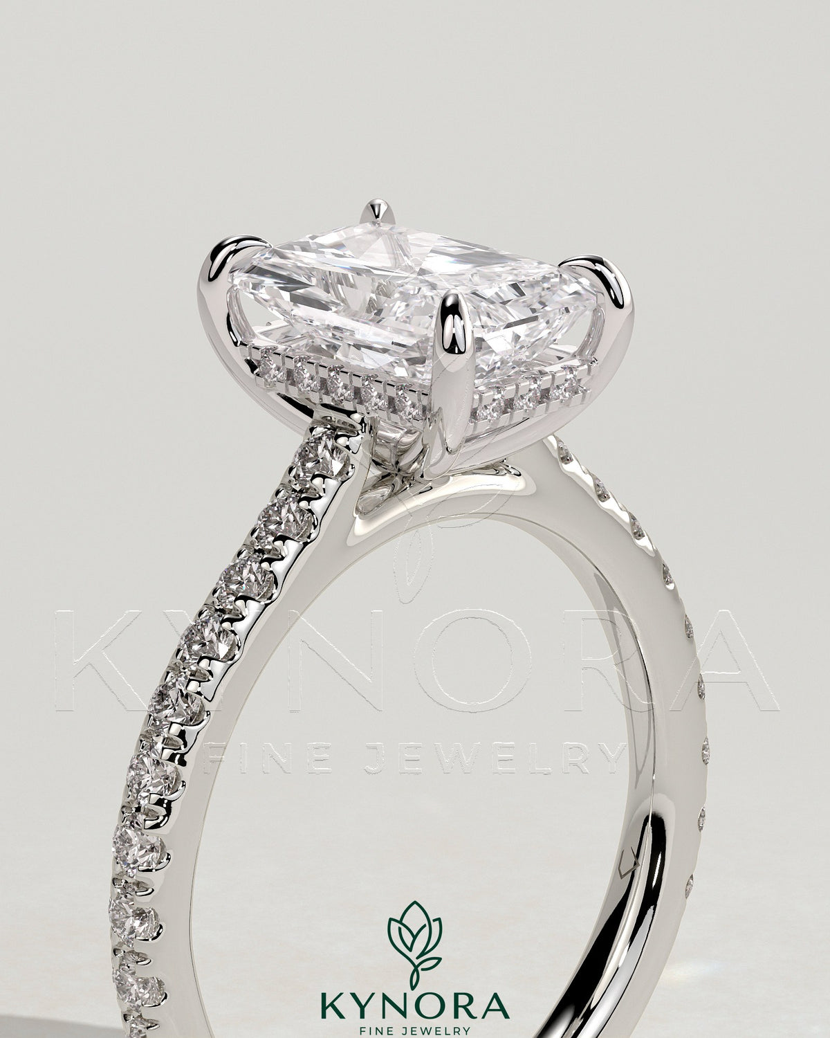 Kynora CJ 2ct radiant diamond claw solitaire engagement ring with hidden halo, pave band, and cathedral high setting.