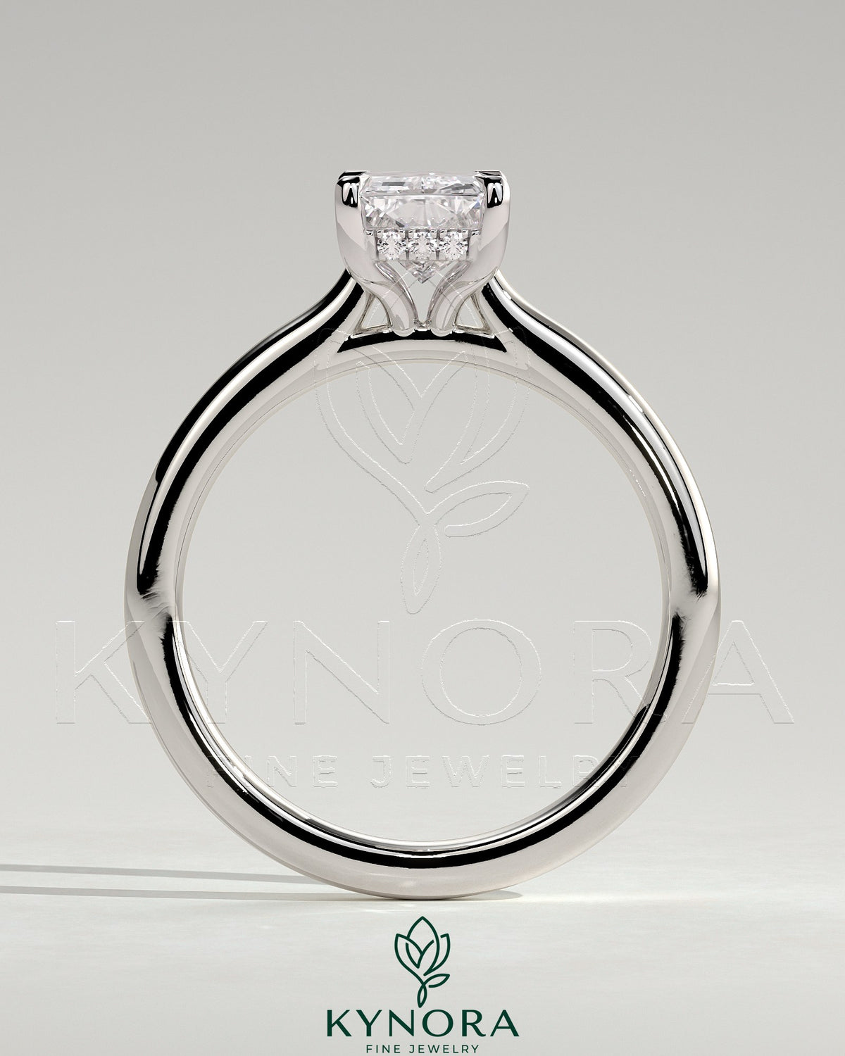Kynora CJ 2ct radiant diamond claw solitaire engagement ring with hidden halo, tapered band, and cathedral high setting.