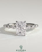 Kynora CJ 2ct radiant claw solitaire engagement ring with marquise and round accent stones, showcasing a sparkling elegant design.