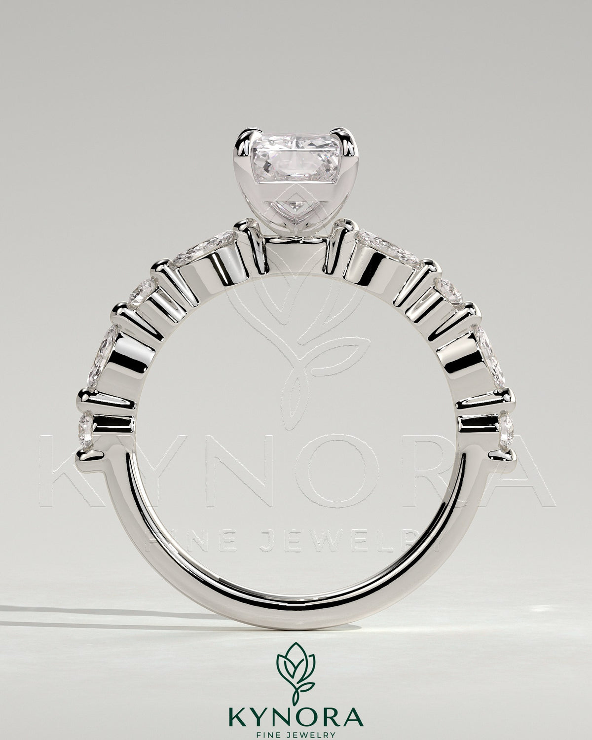 Kynora CJ 2ct radiant claw solitaire engagement ring with marquise and round accent stones, elegant and sparkling jewelry piece.