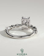 Kynora CJ 2ct radiant claw solitaire engagement ring with marquise and round accent stones, featuring a hidden halo design.