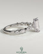 Kynora CJ 2ct radiant claw solitaire engagement ring with marquise and round accent stones and a hidden halo design.