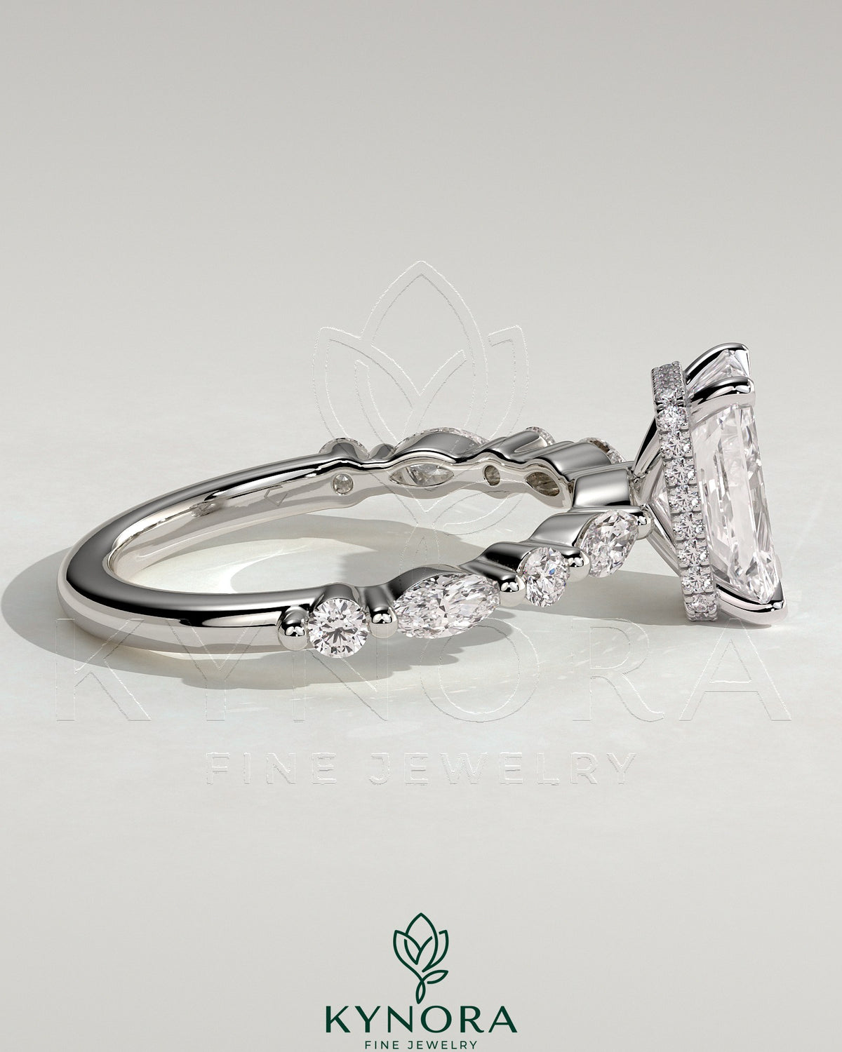 Kynora CJ 2ct radiant claw solitaire engagement ring with marquise and round accent stones and a hidden halo design.