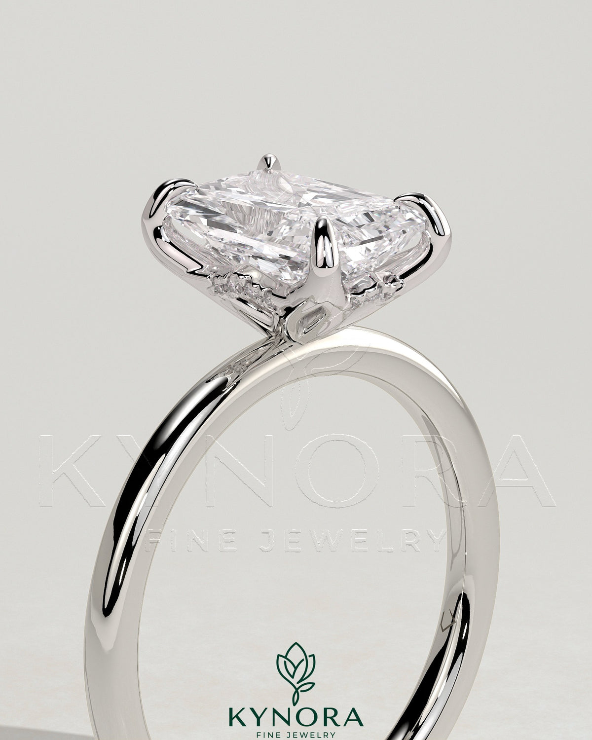 Kynora CJ 2ct radiant claw solitaire engagement ring with petal gallery and accented tiara detail, featuring a sparkling central diamond.
