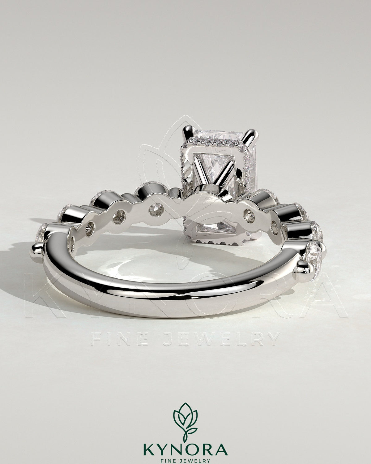 Kynora CJ 2ct radiant claw solitaire engagement ring with round accent stones and hidden halo design in sterling silver