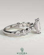 Kynora CJ 2ct radiant claw solitaire engagement ring with round accent stones and hidden halo design, crafted in fine jewelry style.