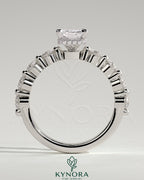 Kynora CJ 2ct radiant claw solitaire engagement ring with round accent stones and hidden halo, crafted in elegant design.