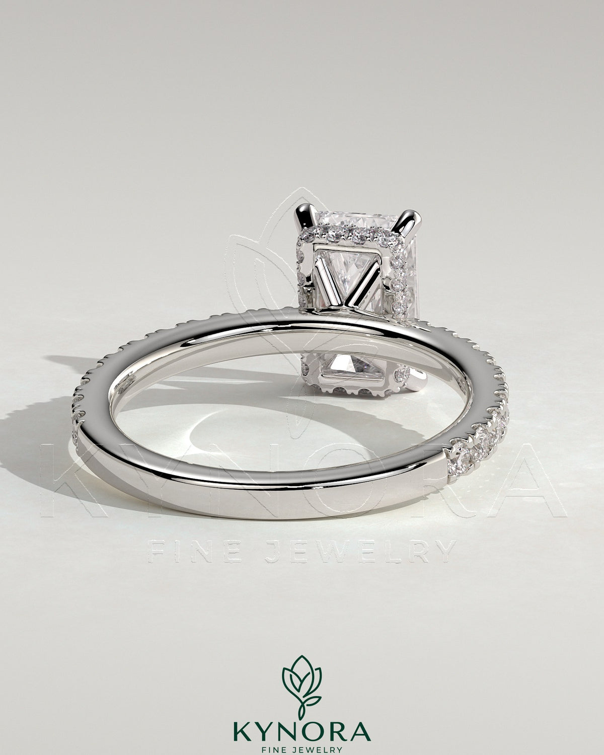 Kynora CJ 2ct radiant claw solitaire engagement ring with wrap-around hidden halo and pave band, sparkling and elegant.