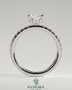 Kynora CJ 2ct radiant diamond claw solitaire engagement ring with wrap-around hidden halo and pave band design.
