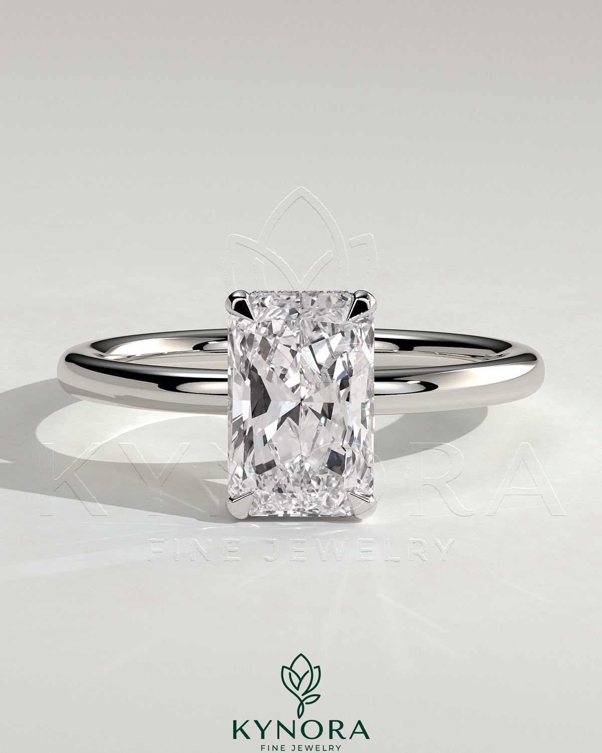 Kynora CJ 2ct radiant cut solitaire engagement ring with wrap-around hidden halo and elegant band design.