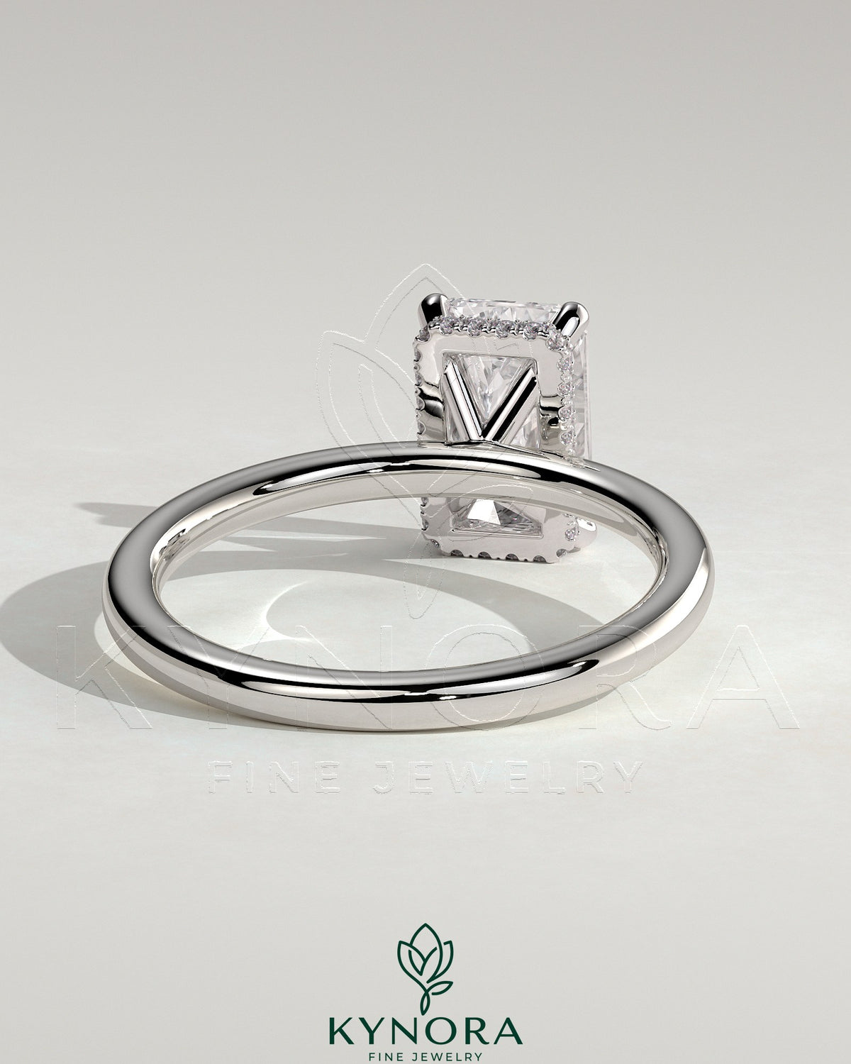 Kynora CJ 2ct radiant claw solitaire engagement ring with wrap-around hidden halo, featuring a sparkling central diamond.