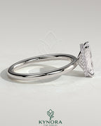 Kynora CJ 2ct radiant claw solitaire engagement ring with wrap-around hidden halo, featuring a sparkling central diamond.