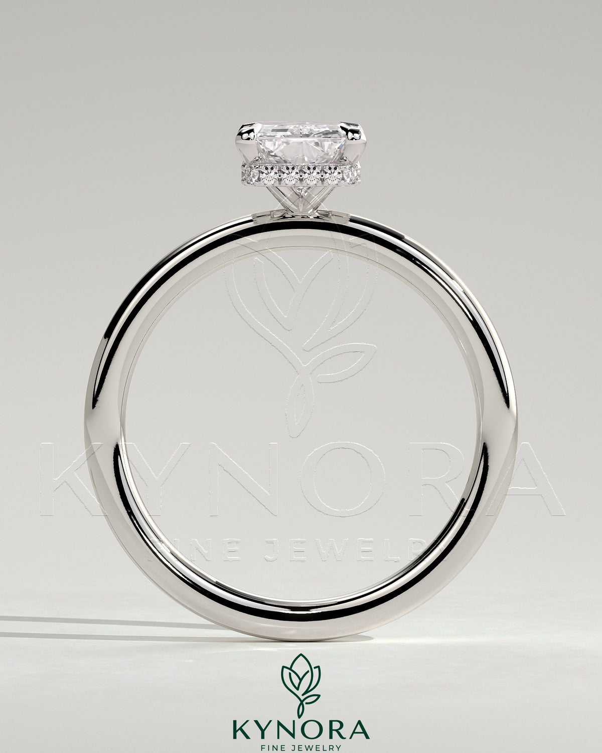 Kynora CJ 2ct radiant claw solitaire engagement ring with wrap-around hidden halo and sleek band, showcasing sparkling diamond details.