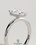 Kynora CJ 2ct radiant claw solitaire engagement ring with a wrap-around hidden halo setting, showcasing sparkling diamond details.