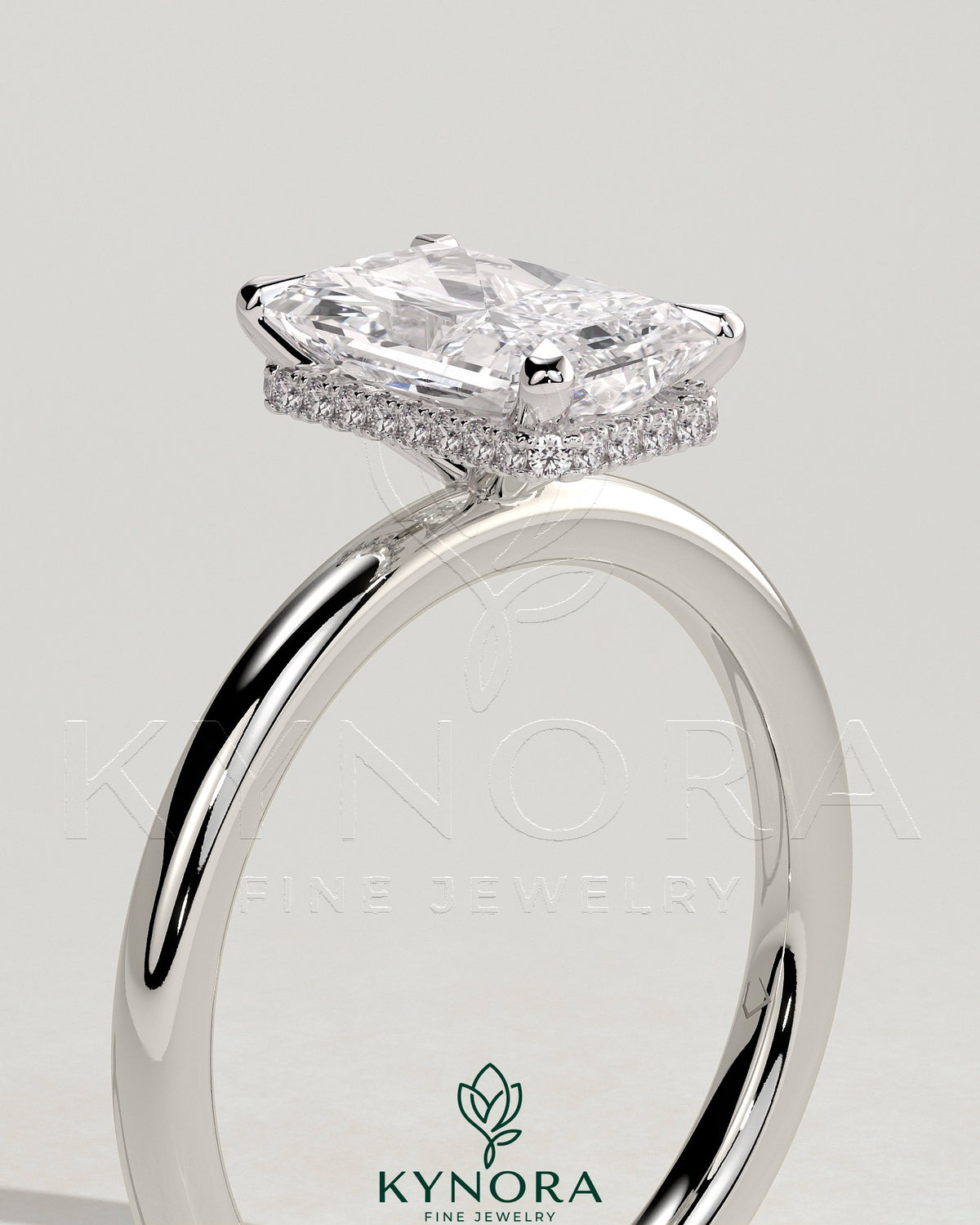 Kynora CJ 2ct radiant claw solitaire engagement ring with a wrap-around hidden halo setting, showcasing sparkling diamond details.