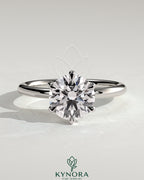 Kynora CJ 2ct round claw solitaire engagement ring featuring a sparkling central diamond and sleek band design.