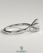Kynora CJ 2ct round claw solitaire engagement ring featuring a sparkling central diamond on a sleek band.