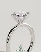 Kynora CJ 2ct round claw solitaire engagement ring with a single sparkling diamond on a sleek band.