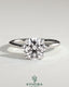 Kynora CJ 2ct round moissanite solitaire engagement ring with claw setting in sterling silver, stylish and elegant jewelry piece.