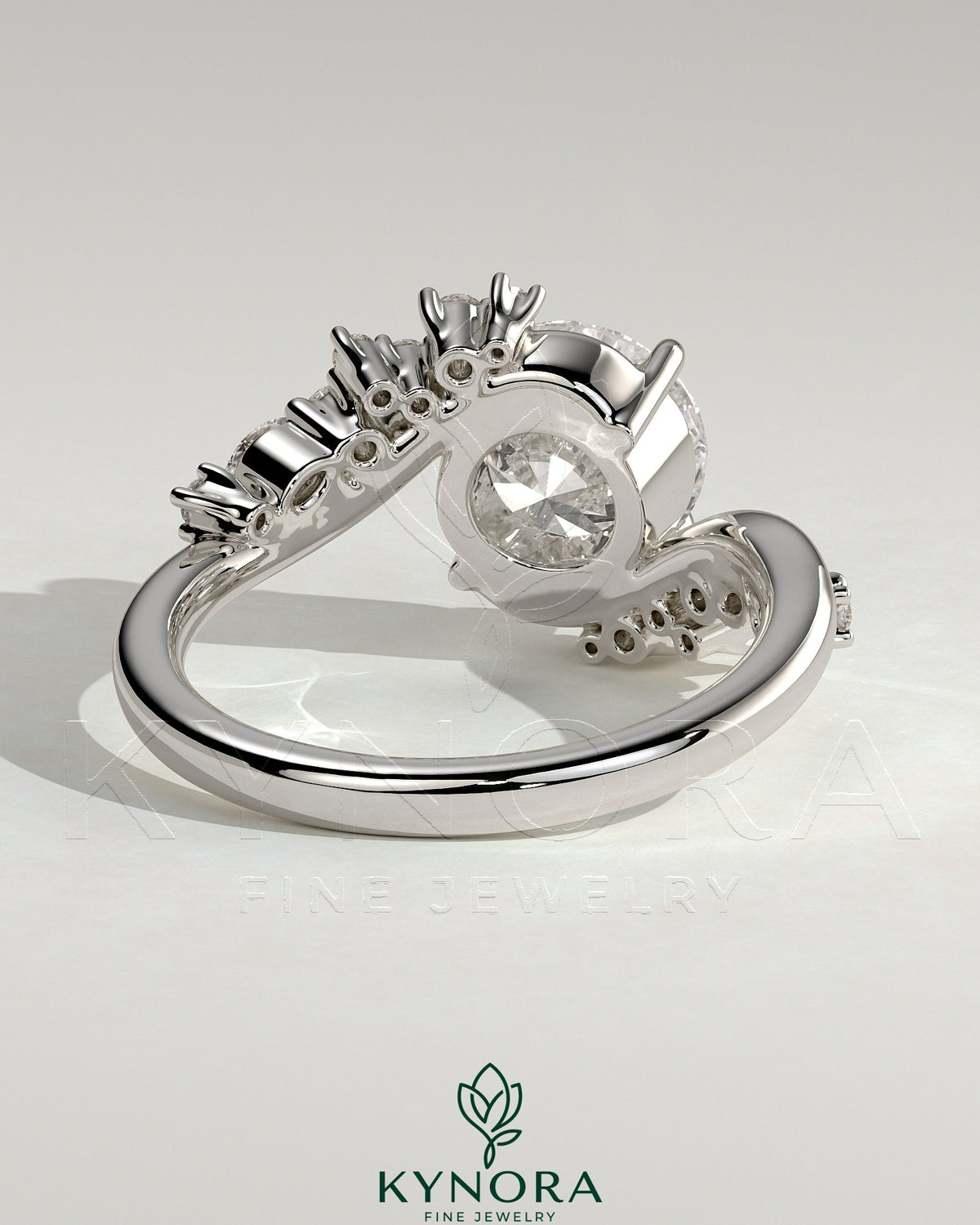 Kynora CJ 2ct round claw solitaire engagement ring with bypass band and clustered round-marquise accent stones, elegant jewelry.