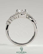 Kynora CJ 2ct round claw solitaire engagement ring with bypass band and clustered round-marquise accent stones.