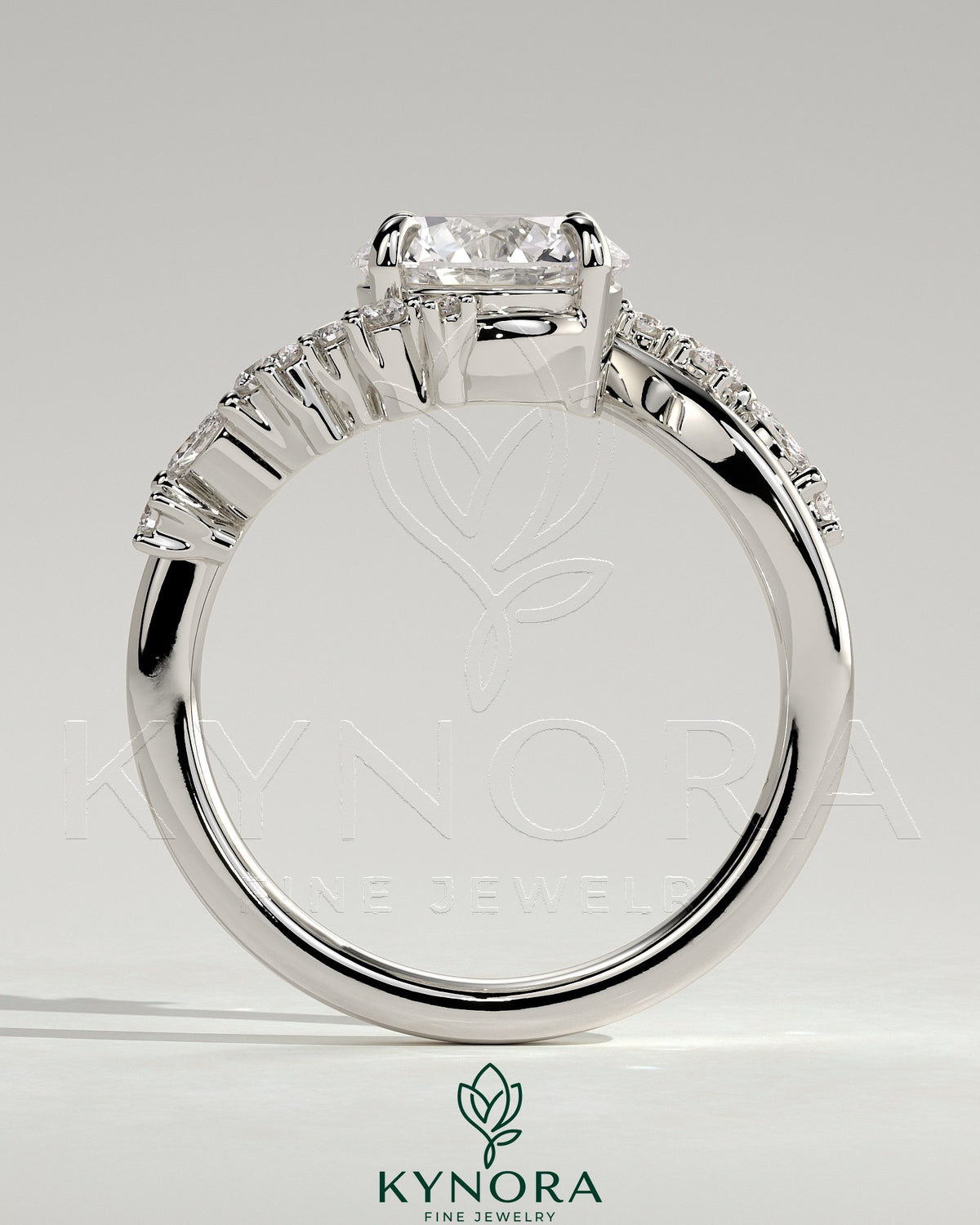 Kynora CJ 2ct round claw solitaire engagement ring with bypass band and clustered round-marquise accent stones.