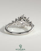 Kynora CJ 2ct round claw solitaire engagement ring with clustered round shoulder stones, elegant and sparkling jewelry piece