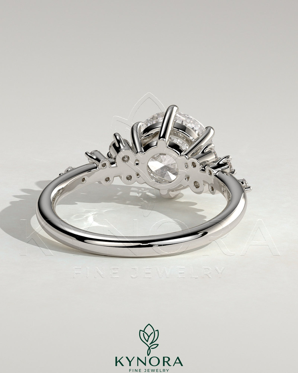 Kynora CJ 2ct round claw solitaire engagement ring with clustered round shoulder stones, elegant and sparkling jewelry piece