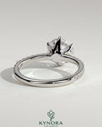 Kynora CJ 2ct round claw solitaire engagement ring with crown gallery and pave band, showcasing elegant diamond craftsmanship.