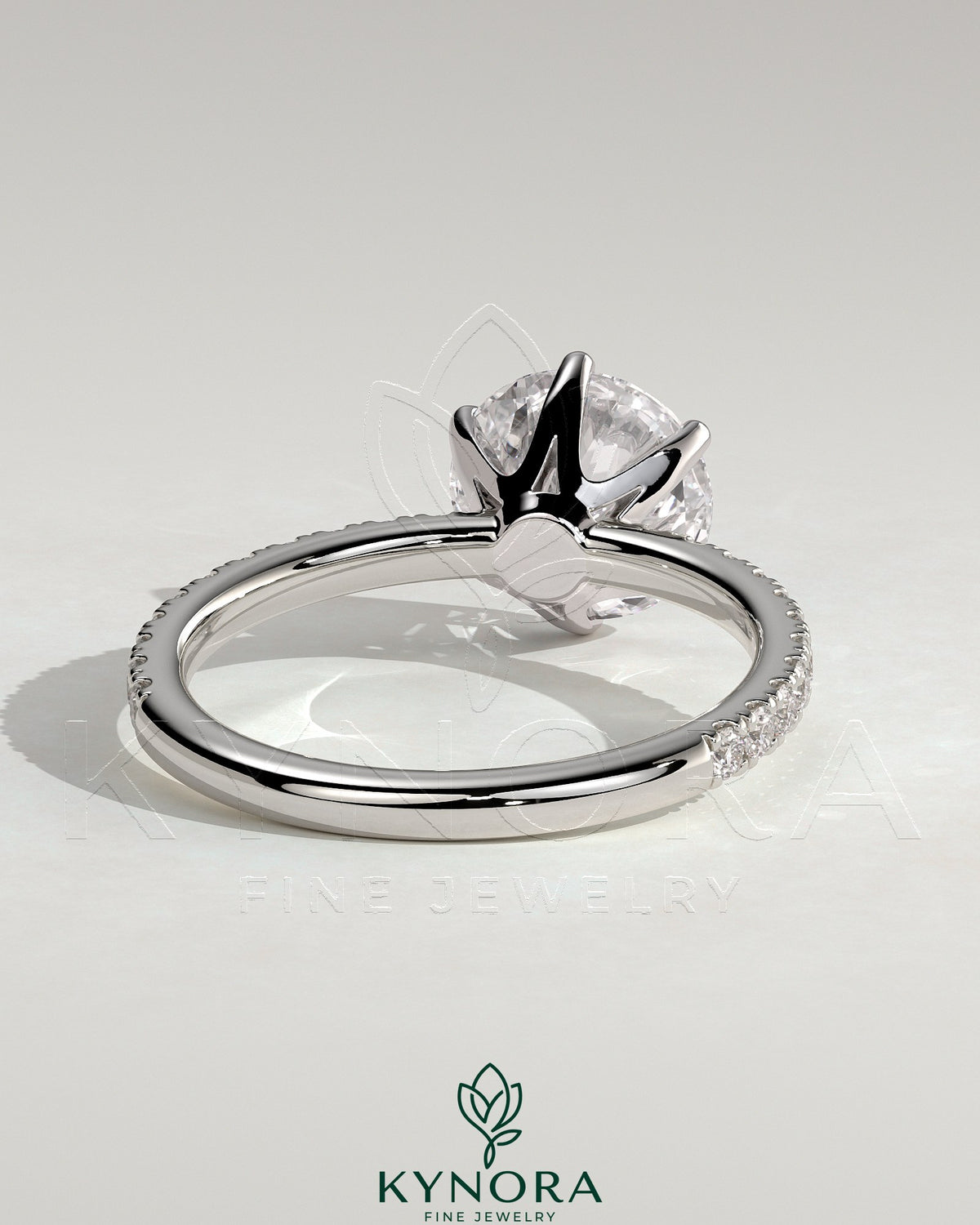 Kynora CJ 2ct round claw solitaire engagement ring with crown gallery and pave band, showcasing elegant diamond craftsmanship.