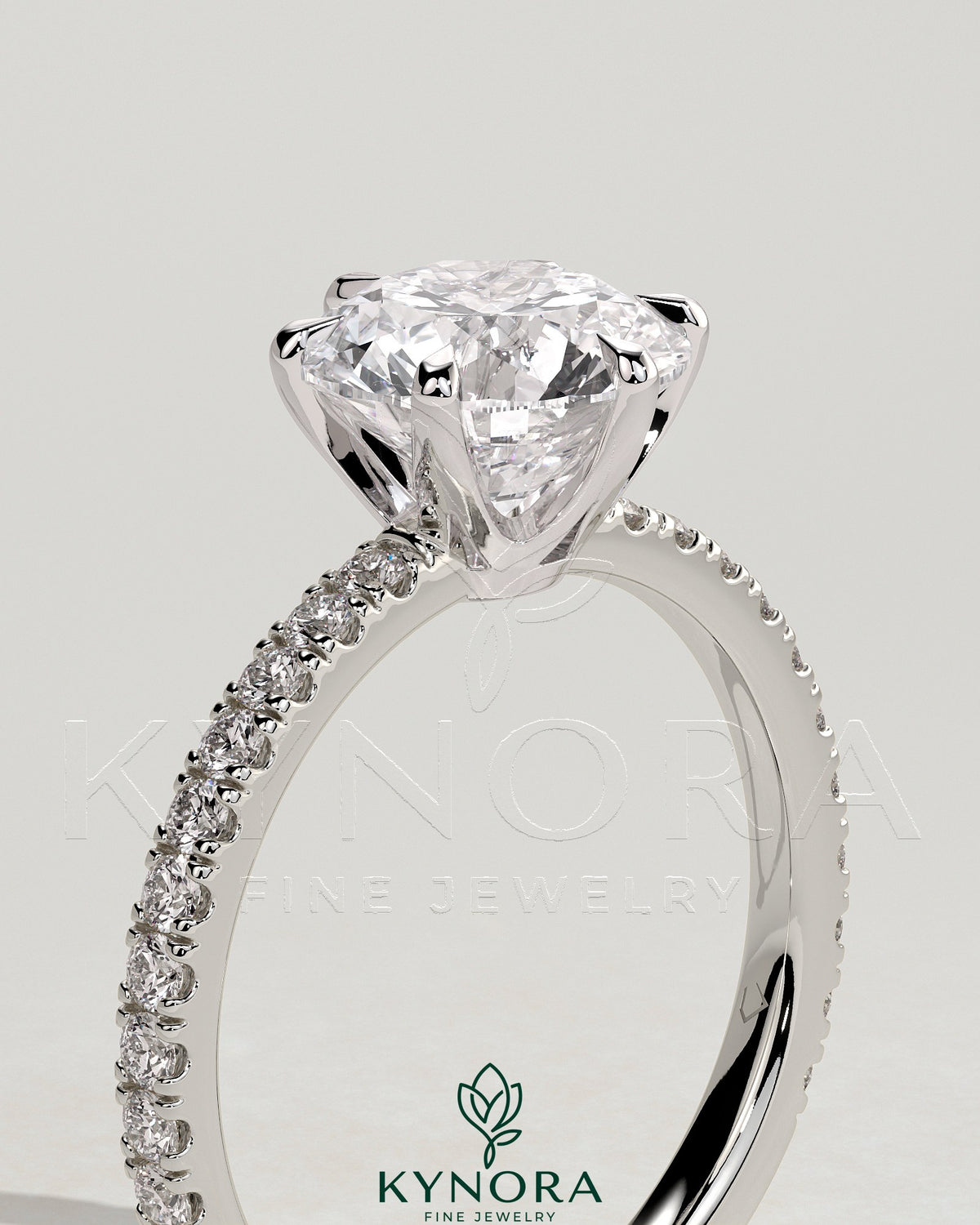 Kynora CJ 2ct round claw solitaire engagement ring with crown gallery and pave band, showcasing elegant diamond setting.