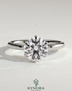 Kynora CJ 2ct round claw solitaire engagement ring with crown gallery setting showcasing a sparkling diamond on a sleek band.
