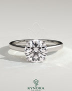Kynora CJ 2ct round diamond claw solitaire engagement ring with flat band and cathedral high setting.